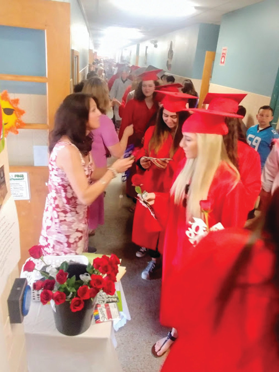 SPECIAL TOKEN: Lisa Davis had a rose for each senior who was a former student of hers. This year’s graduating class was her first class at Glen Hills Elementary School.